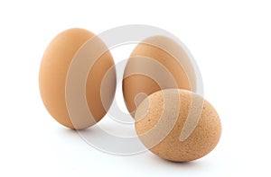 Three brown chicken eggs.