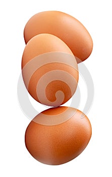 Three brown chicken eggs in stack isolated on white background with clipping path