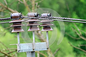 Three brown insulators with wires