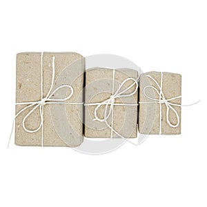 Three brown natural packaged gifts or presents with ribbon