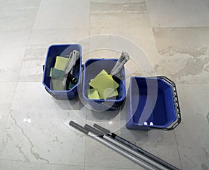 Three buckets with different tools for cleaning floor