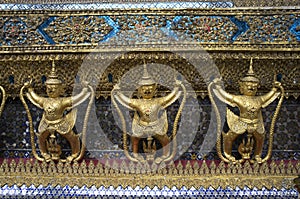 Three Buddha on decorated wall