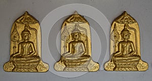 Three Buddha on Gray wall background. photo