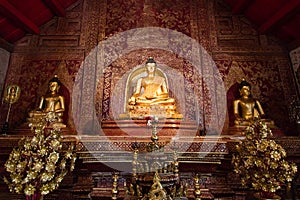 Three Buddha images sitting inside Wat Phra Singh, Thailand