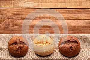 Three buns on wooden table