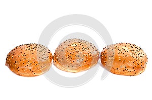 Three burger buns with sesame seeds on white background