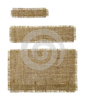 Three burlap rectangular and oblong pieces isolated on white background. Natural color sackcloth patch with torn edges. Rough