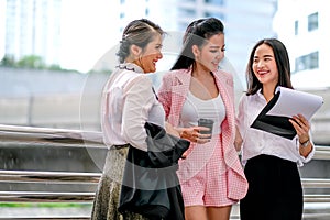 Three business Asian girls are acting as happy and exciting outside the office during day time