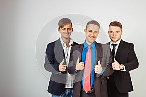 Three business men in suits standing like a team