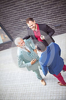 Three business men talking.