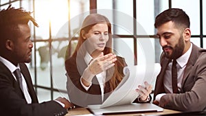 Three business people in the office working together.