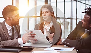 Three business people in the office working together.