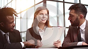 Three business people in the office working together.