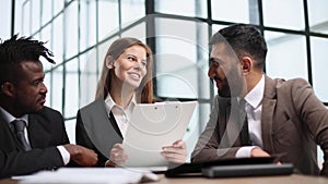 Three business people in the office working together.