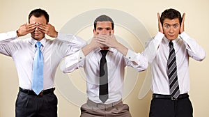 Three businessman covering eyes, mouth and ears