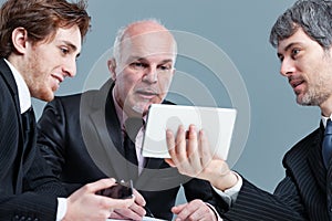 Three businessman having an animated discussion