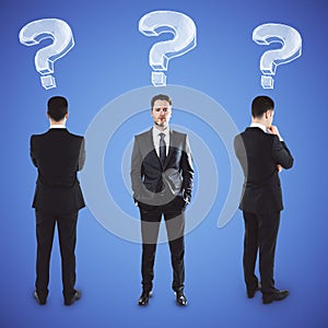 Three businessmans with question marks