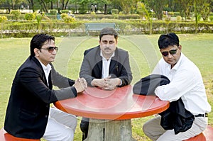 Three businessmen discussing plan in park