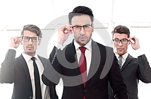 Three businessmen with glasses, pretentious looking at the camera photo