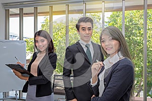 Three businessmen in the meeting room. Team of Asian business posing in meeting room at office. Working brainstorming at spacious