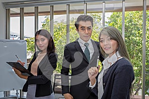 Three businessmen in the meeting room. Team of Asian business posing in meeting room at office. Working brainstorming at spacious