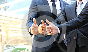 Three businessmen in team work thumbs up when they choose the best plan