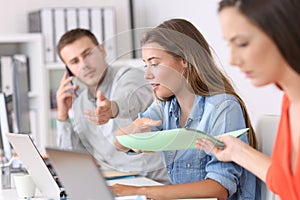 Three businesspeople working hard at office