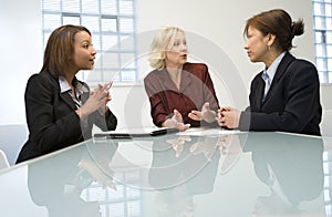 Three businesswomen in meeting photo