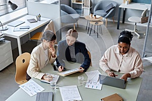 Three Busy Business Women Working at Office Desk