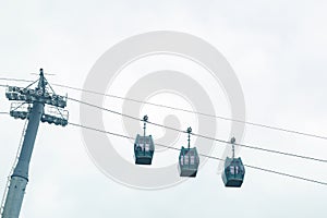 Three cable cars against cloudy sky in summer