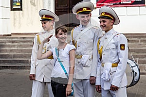 Three cadets with drums flirt with girl