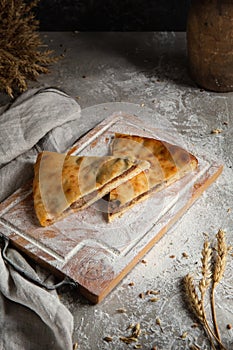 Two piace of cakes on wooden board and gray background photo