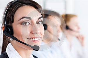 Three call center service operators at work