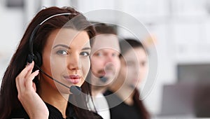Three call centre service operators at work