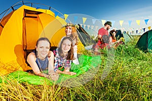 Three campers relaxing in their tent at campsite