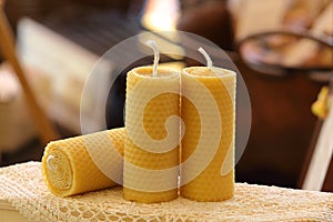 Three candles with beeswax with a beautiful honeycomb texture and a warm winter background