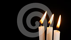 Three Candles Burning and Extinguished on a Black Background, Copy Space