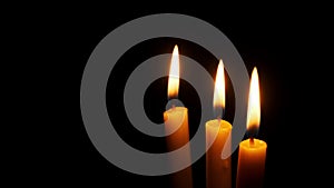 Three Candles Burning and Extinguished on a Black Background, Copy Space