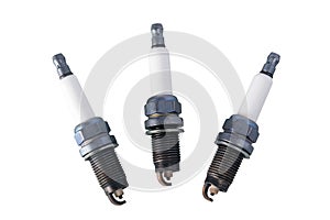 Three candles for a car motor isolated on a white background
