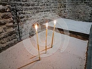 Three candles in the church. Symbol of  life, hope and death