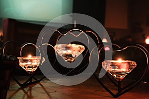 three candles flaming in the dark interior closeup