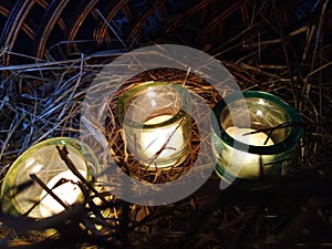 Three candles in glass candlesticks