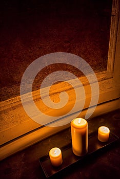 Three candles lying on the floor of an ancient building