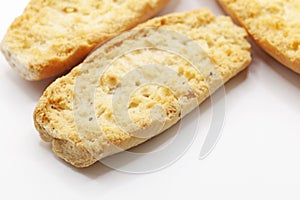 three cardamom biscuits on white background