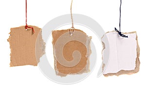 Three cardboard tags hanging on white background