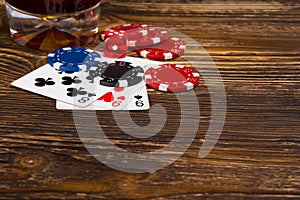 Three cards, poker chips, on a wooden background