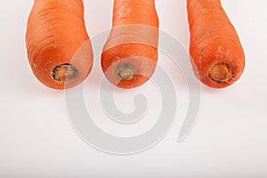 Three carrots on white background