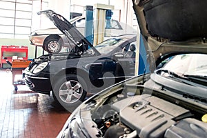 Three cars in a repair shop