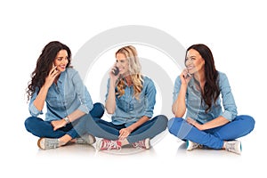 Three casual women sitting and speak on the phone