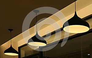 Three ceiling pendant lampshades lighting up the warm light